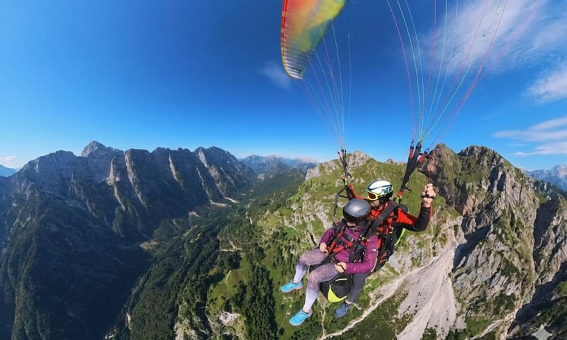 Tandem paragliding flight over the Soča Valley